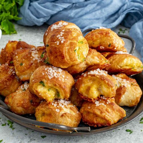 Soft pretzel bites stuffed with cheese and jalape&ntilde;o, baked until golden and glossy, ready for dipping.