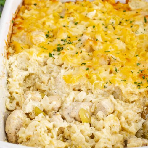 Close-up of creamy Mississippi Chicken Casserole showing tender chicken, egg noodles, melted cheese, and sliced pepperoncini.