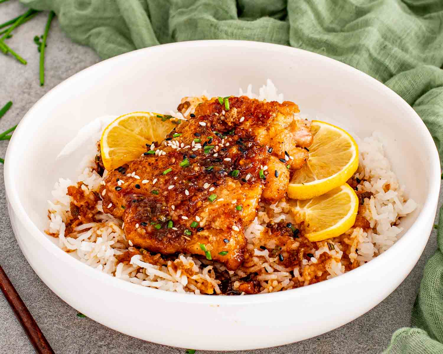 Golden honey lemon garlic chicken thighs glazed in a sticky soy garlic sauce with fresh lemon slices.