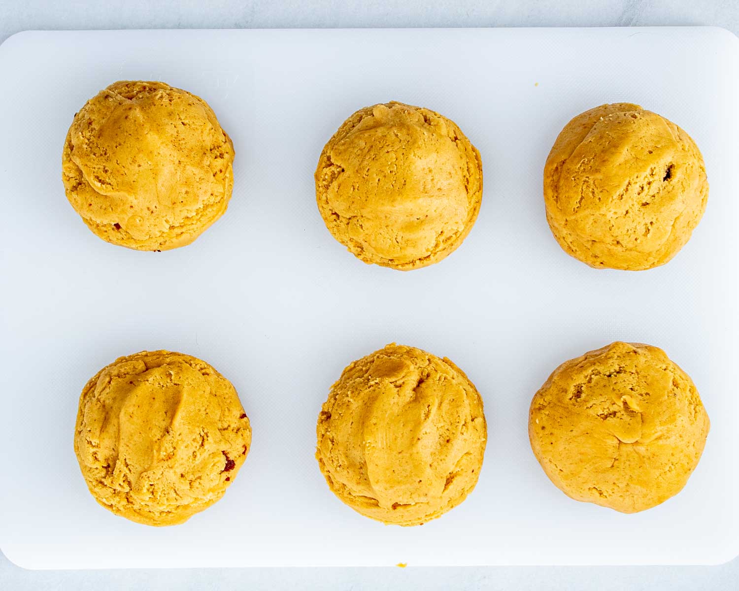 process shots showing how to make cinnamon roll cookies with cream cheese glaze.