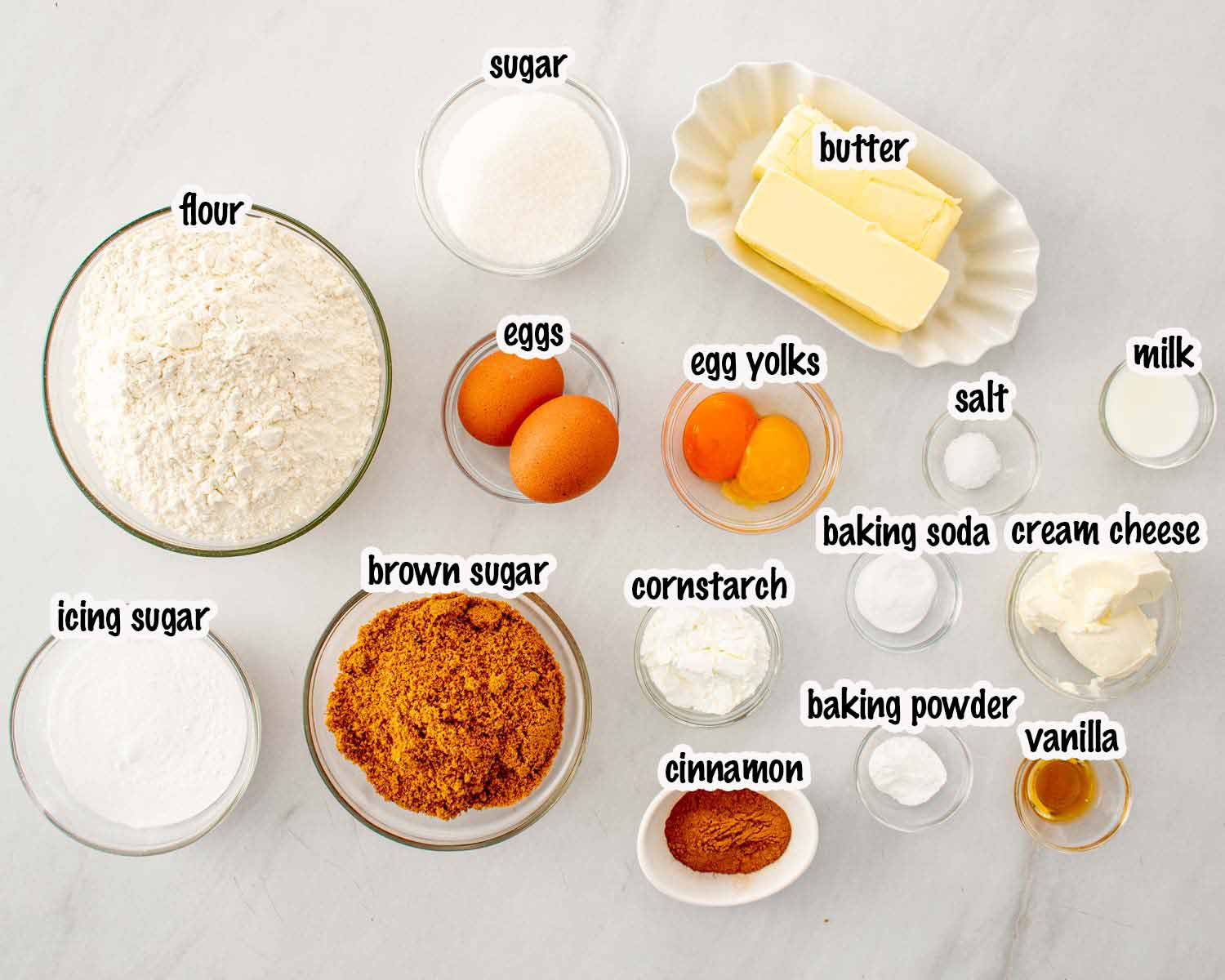 Ingredients for cinnamon roll cookies including flour, sugars, butter, eggs, cream cheese, cinnamon, cornstarch, baking soda, baking powder, and vanilla.