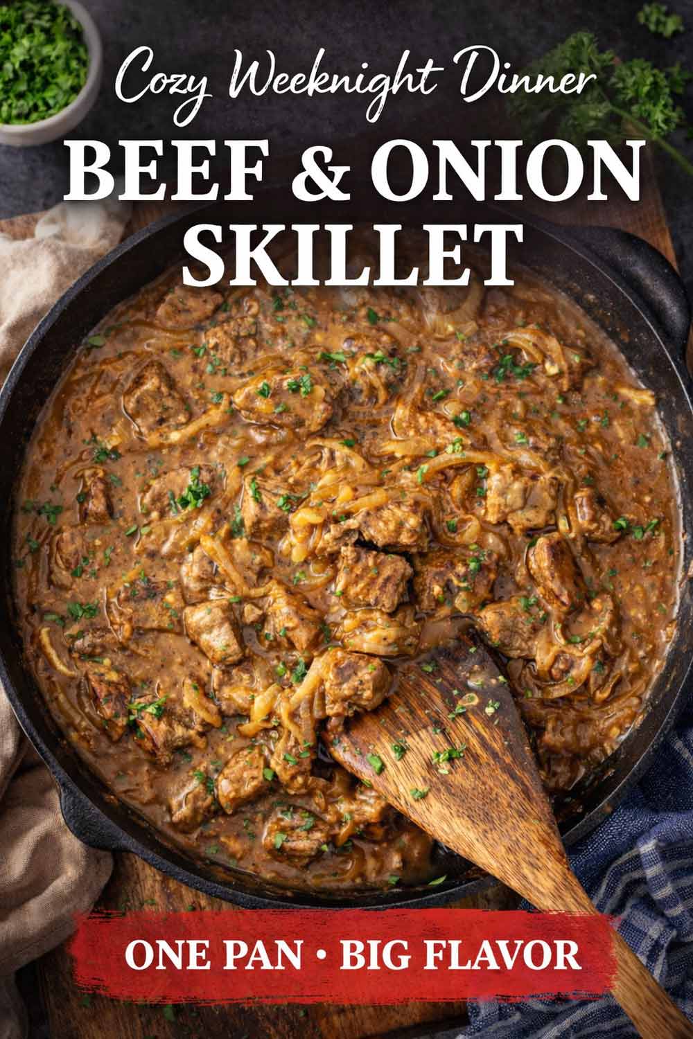 Beef and onion skillet in a cast iron pan with rich gravy, caramelized onions, and herbs, cozy weeknight dinner concept.