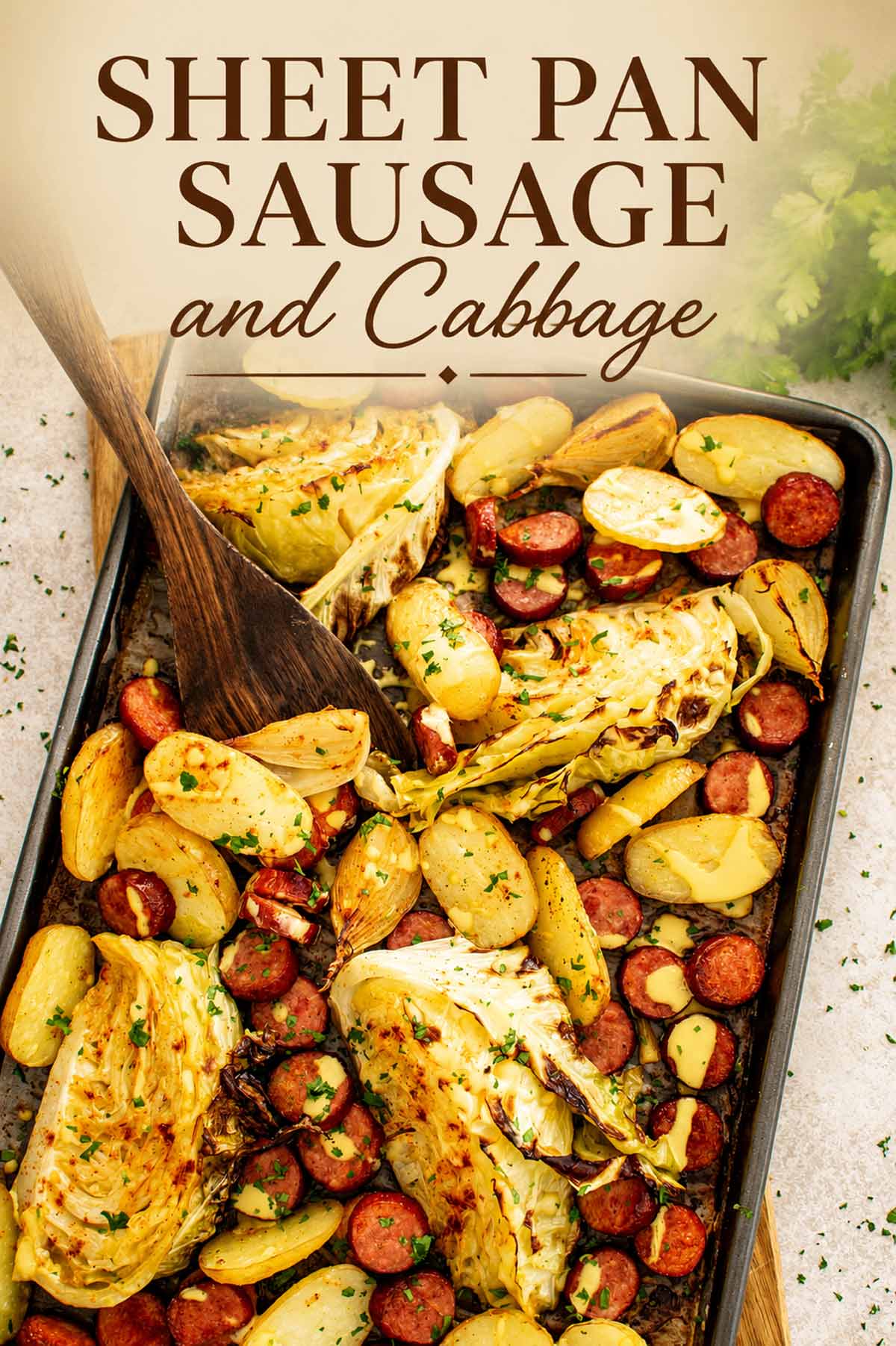 Overhead Pinterest pin of sheet pan sausage and cabbage with roasted potatoes and Dijon drizzle with script text overlay.