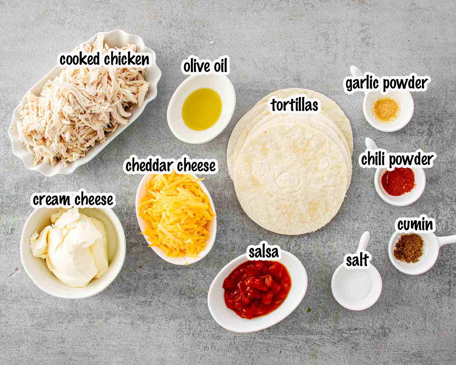 Ingredients for homemade chicken taquitos including shredded chicken, tortillas, cheddar, cream cheese, salsa, olive oil, and seasonings.