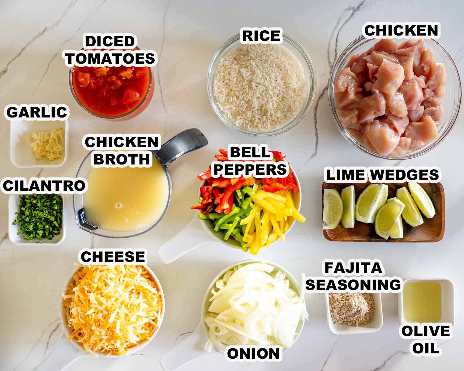 Overhead display of labeled chicken fajita rice casserole ingredients, including chicken, rice, peppers, cheese, tomatoes, onion, and seasonings.