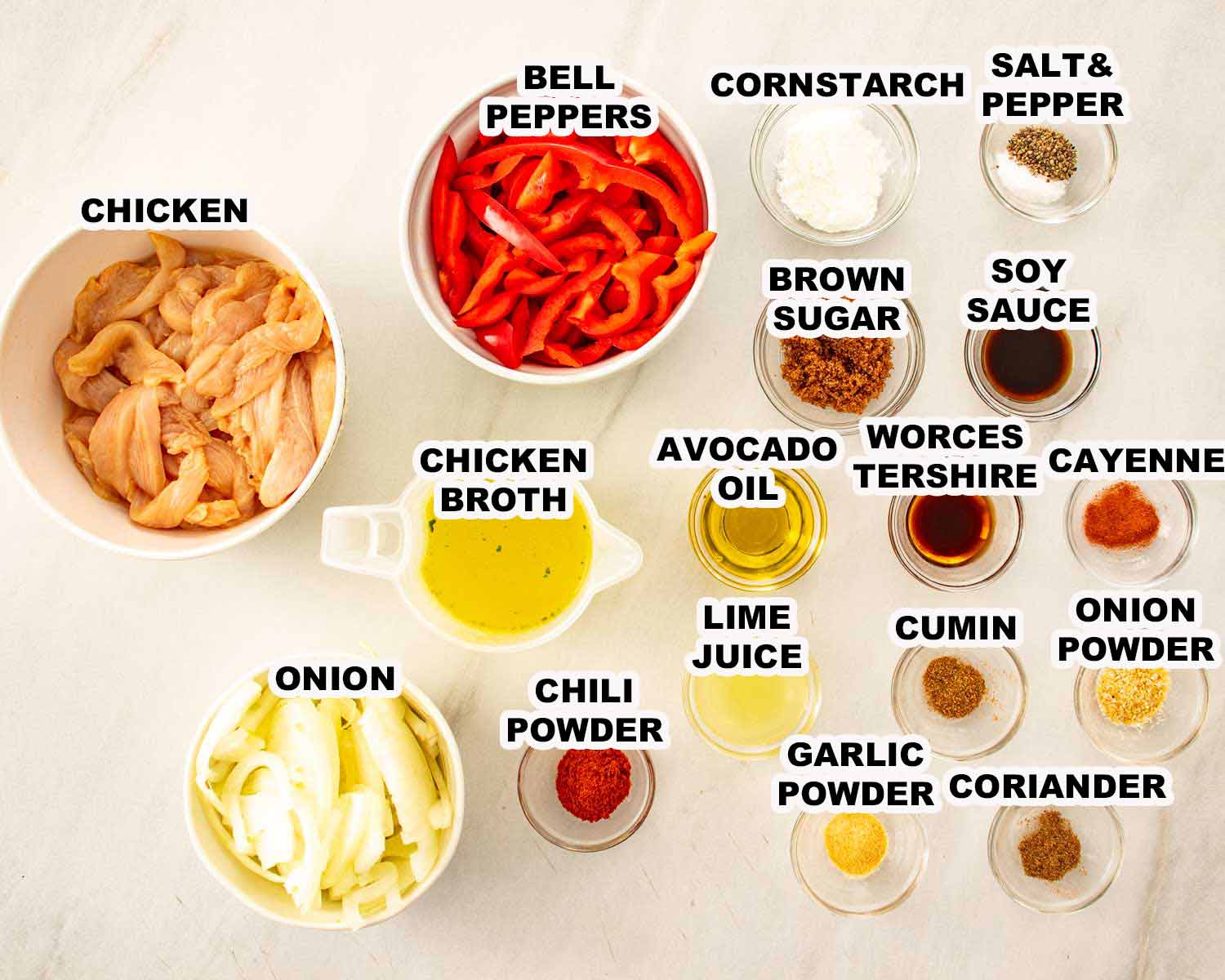 Overhead display of labeled chicken fajita ingredients, including sliced chicken, bell peppers, onion, seasonings, sauces, broth, and lime juice.