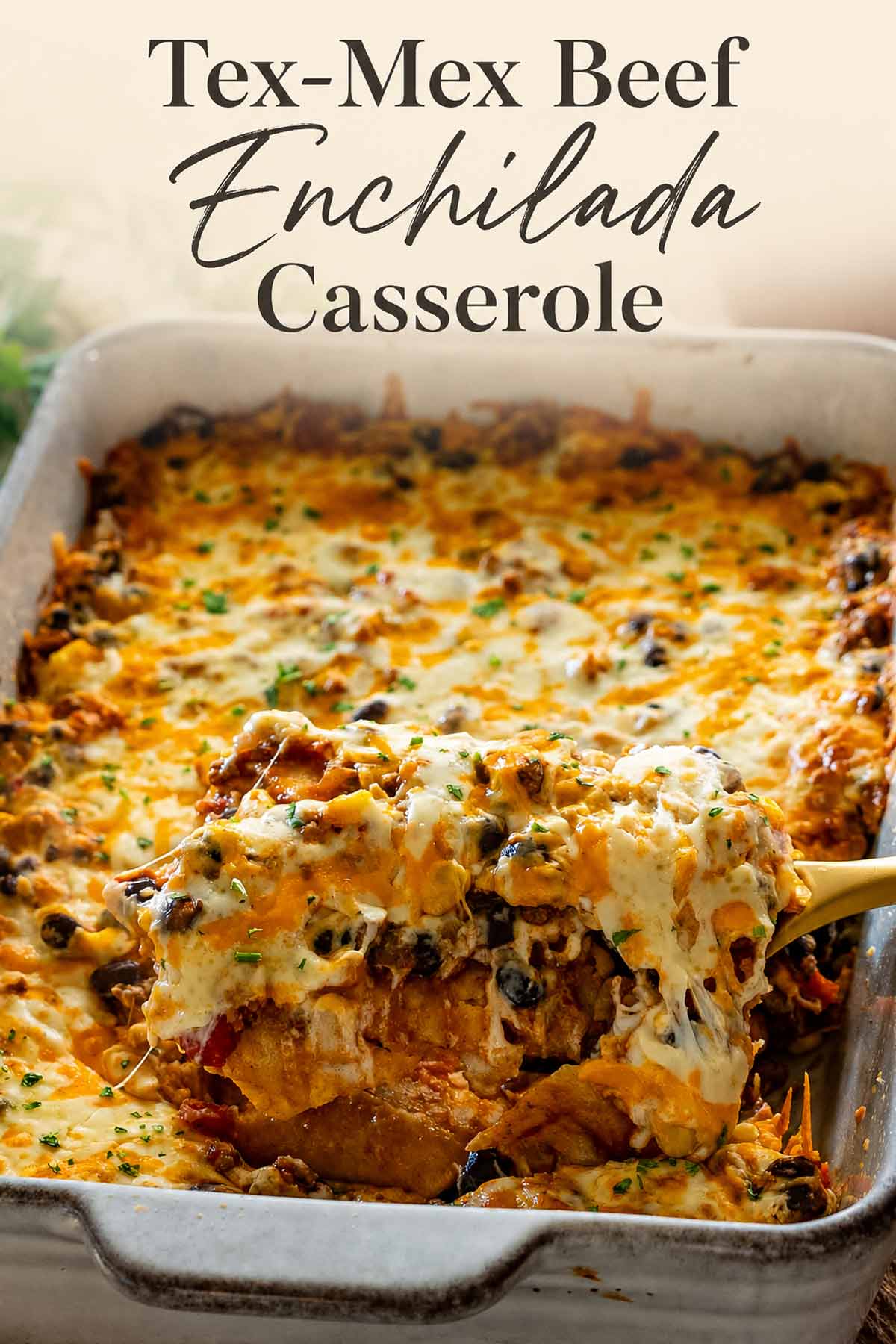 Pinterest graphic featuring cheesy Tex-Mex beef enchilada casserole with a lifted serving and elegant recipe title overhead.
