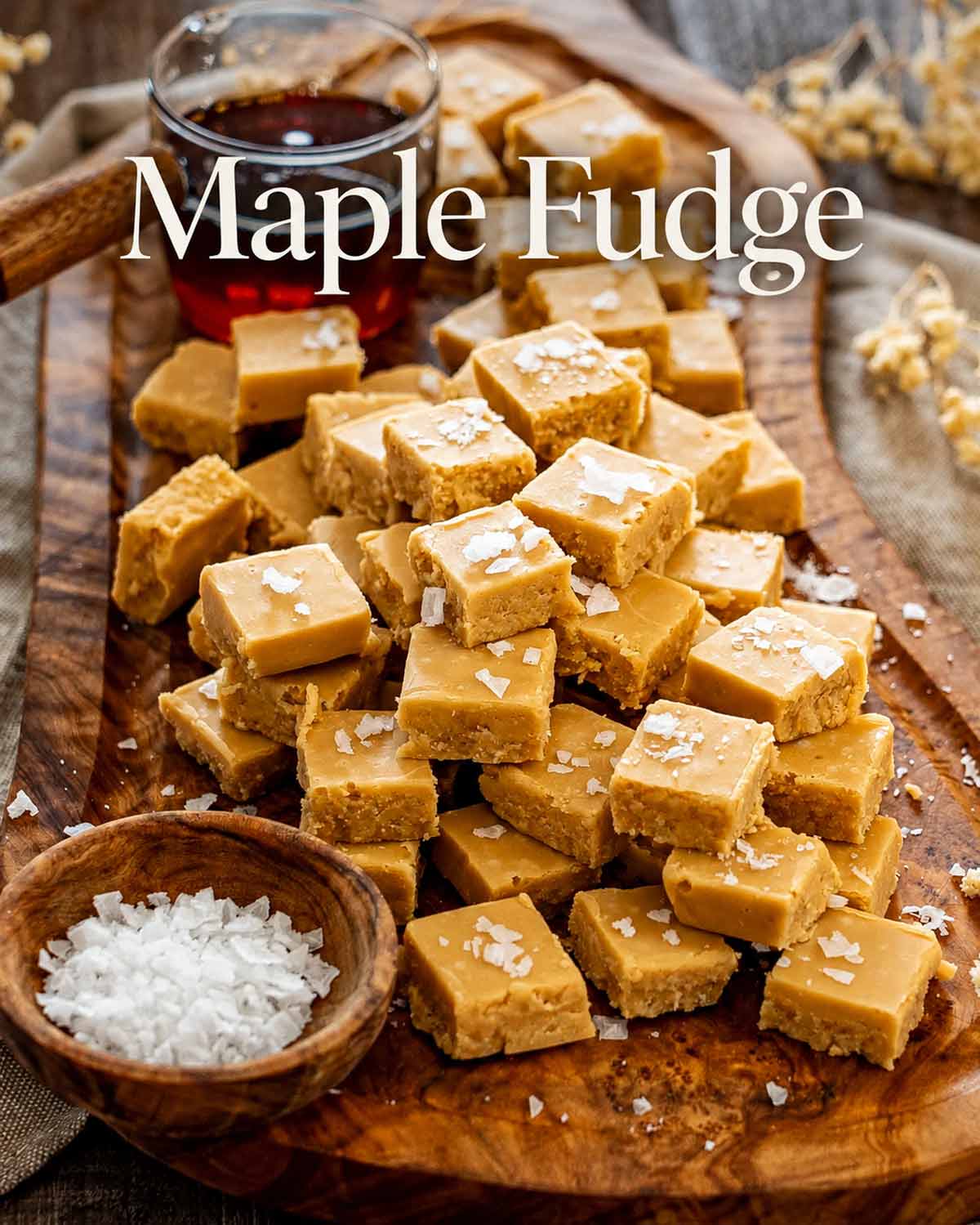Pinterest image featuring salted maple fudge squares, maple syrup, and the recipe title in elegant white lettering.