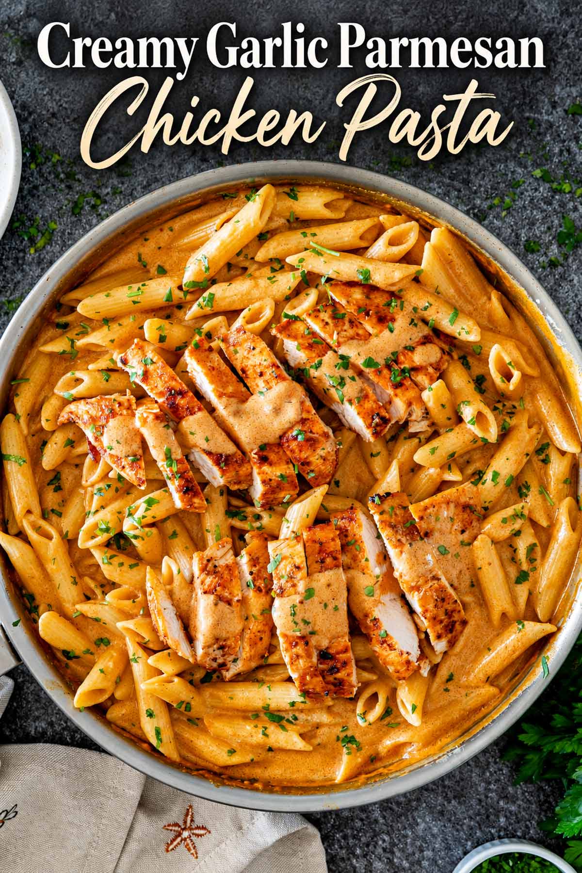 Pinterest graphic featuring creamy garlic Parmesan chicken pasta in a skillet with sliced chicken and an elegant recipe title.