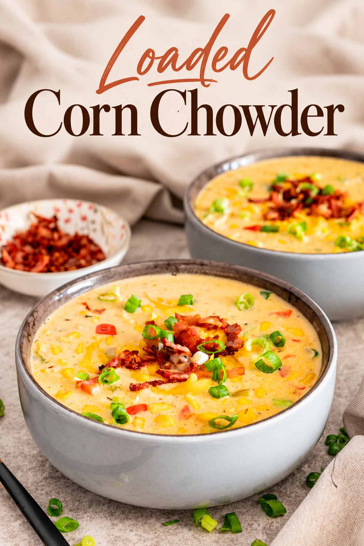 Pinterest graphic featuring two bowls of loaded corn chowder beneath an elegant terracotta and brown recipe title.