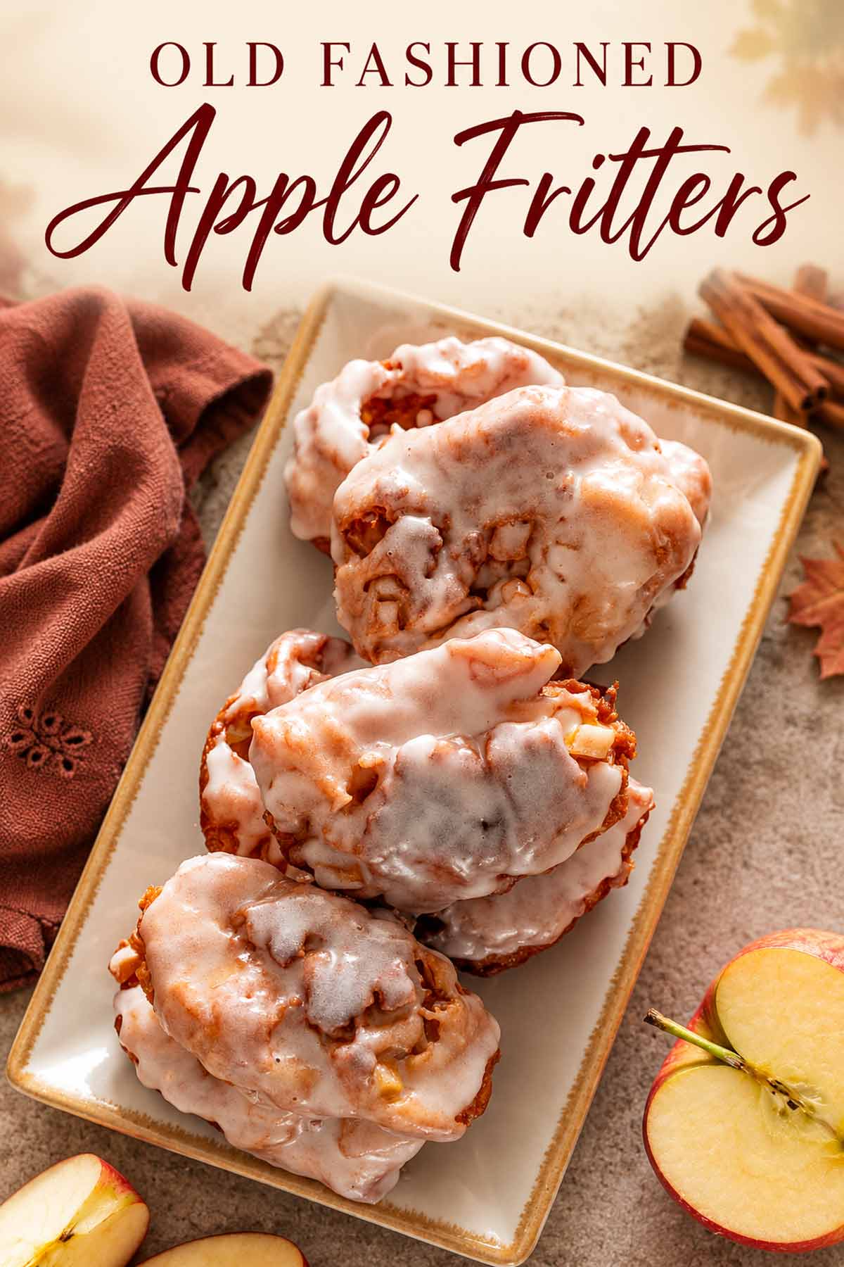 Pinterest graphic featuring glazed apple fritters on a rectangular platter beneath the title Old Fashioned Apple Fritters.
